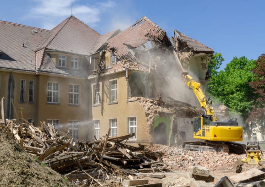 digger demolishing houses for reconstruction.
